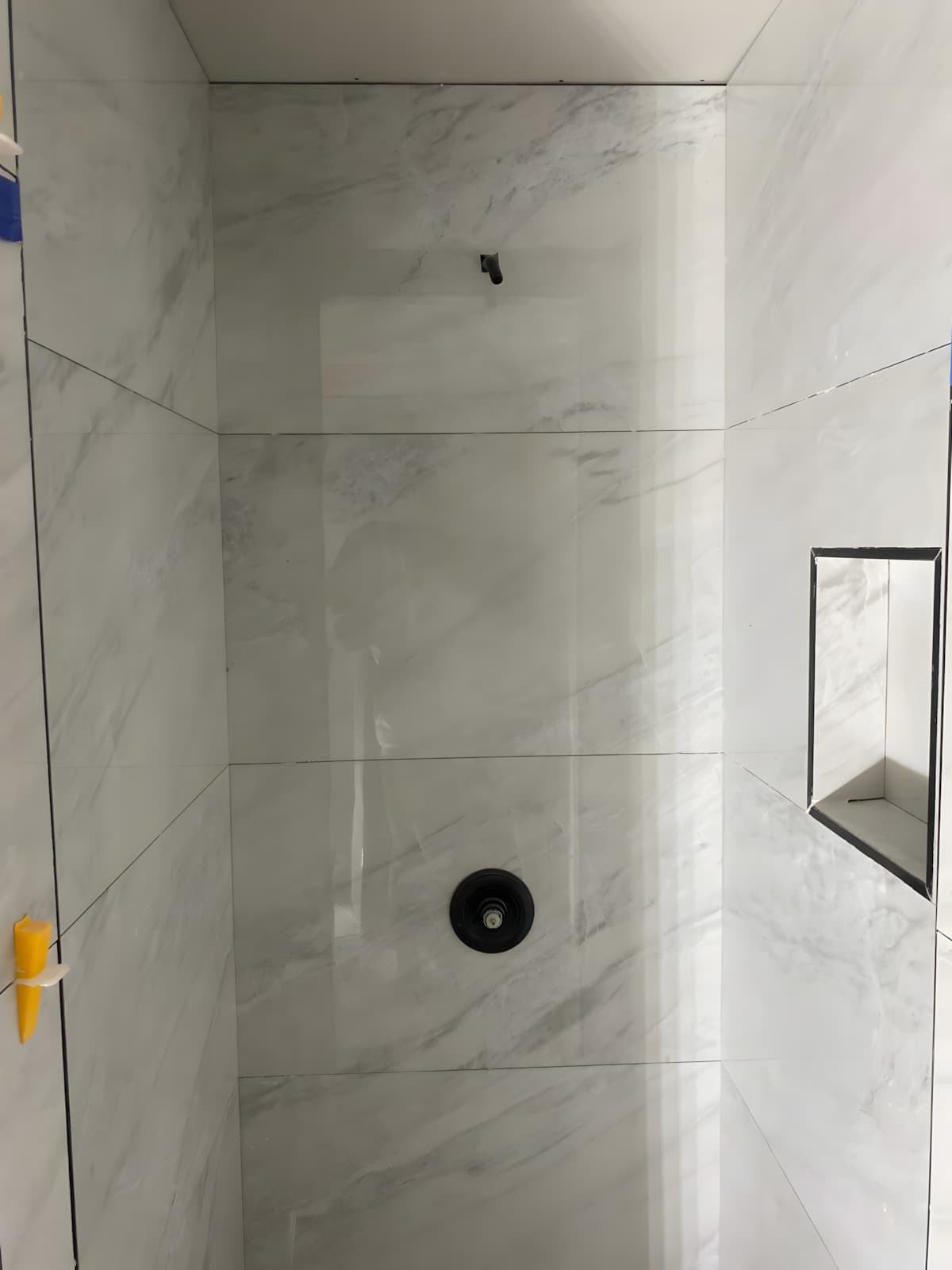Finished shower tiled in marble-look stone
